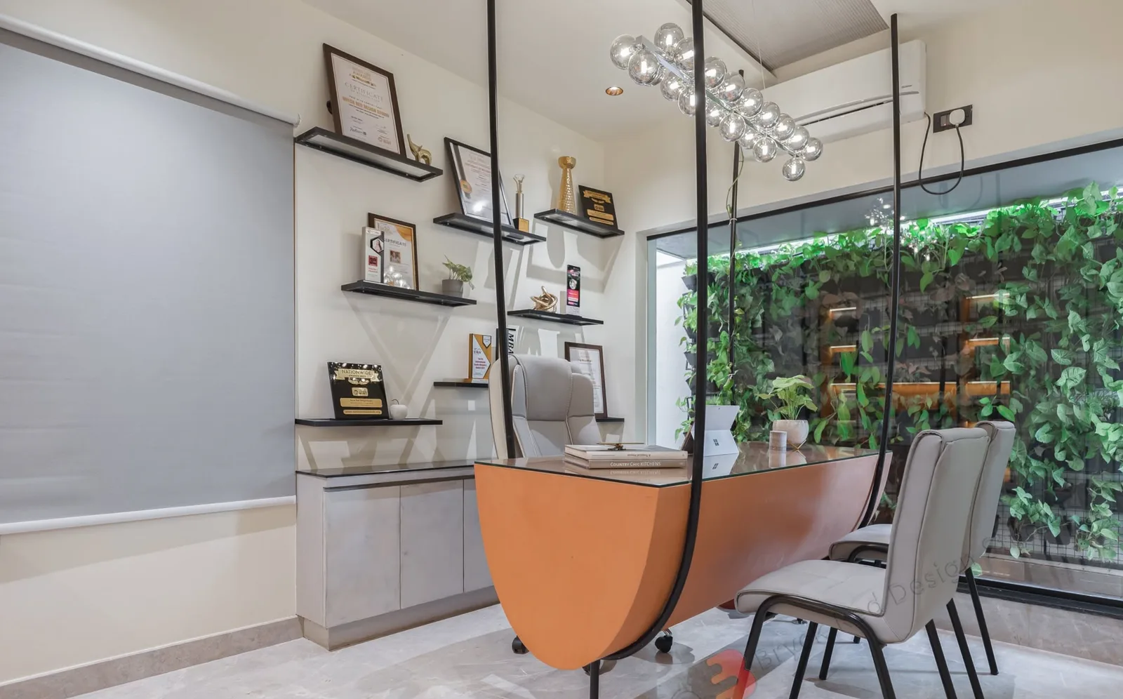 The Bryck Red studio in Bengaluru, with timber furniture, a glazed partition and indoor planting
