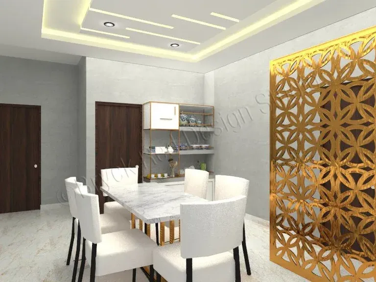 Dining area divided by a laser-cut jali screen.